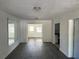 Spacious living room with dark laminate flooring and white trim at 1817 Meridel Ave, Tampa, FL 33612
