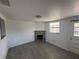 Bright living room features a stone fireplace and dark laminate flooring at 1817 Meridel Ave, Tampa, FL 33612