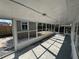Enclosed porch featuring lots of windows and screen for ventilation at 1817 Meridel Ave, Tampa, FL 33612