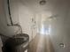 Utility Room featuring a hot water tank, shelving and white walls with tile flooring at 1817 Meridel Ave, Tampa, FL 33612