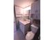 Bathroom features a vanity with a marble countertop and built-in storage and a toilet with a bidet seat at 1900 68Th N St # 104, St Petersburg, FL 33710