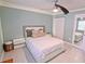 Bedroom with a fan and a plush bed with soft, neutral bedding for a calming and restful atmosphere at 1900 68Th N St # 104, St Petersburg, FL 33710