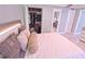 Spacious bedroom featuring a large bed, walk-in closet, and view into ensuite bathroom at 1900 68Th N St # 104, St Petersburg, FL 33710