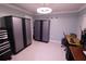 Bonus room with overhead lighting and tile flooring features ample workspace and storage cabinets at 1900 68Th N St # 104, St Petersburg, FL 33710