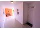 Condo entrance featuring a white door, 'Welcome Home' mat, and nearby bench with orange accent wall at 1900 68Th N St # 104, St Petersburg, FL 33710