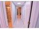 Hallway with white trim and tile flooring that leads to the bathroom and what appears to be another living space at 1900 68Th N St # 104, St Petersburg, FL 33710