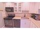 Kitchen with stainless steel appliances, white cabinetry, and light countertops at 1900 68Th N St # 104, St Petersburg, FL 33710