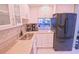 Updated kitchen featuring modern stainless steel appliances, light countertops and white cabinetry at 1900 68Th N St # 104, St Petersburg, FL 33710