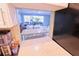 View from the kitchen into the dining and living area with plants and neutral furnishings at 1900 68Th N St # 104, St Petersburg, FL 33710