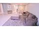 Cozy living room with a gray couch, soft rug, and dining area with white table and chairs at 1900 68Th N St # 104, St Petersburg, FL 33710