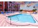 Community pool with poolside seating under a colorful sky at 1900 68Th N St # 104, St Petersburg, FL 33710