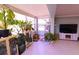 Well-lit sunroom filled with plants, a cozy chair and a television set for relaxing at 1900 68Th N St # 104, St Petersburg, FL 33710