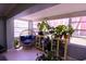 Bright sunroom with large windows, a cozy chair and lots of plants at 1900 68Th N St # 104, St Petersburg, FL 33710