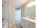Bathroom featuring a vanity with marble countertop and a shower with marble-style tiles at 2105 Clover Hill Rd, Palm Harbor, FL 34683