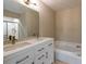 Luxurious bathroom featuring dual sinks, granite countertops and a soaking tub at 2105 Clover Hill Rd, Palm Harbor, FL 34683