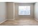 Bright bedroom with a large window providing natural light and wood floors at 2105 Clover Hill Rd, Palm Harbor, FL 34683