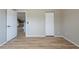 Bedroom with a closet, and a view into the hallway with wood-style floors at 2105 Clover Hill Rd, Palm Harbor, FL 34683