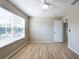 Bedroom with a ceiling fan, wood-style flooring, a window with blinds, and neutral-colored walls at 2105 Clover Hill Rd, Palm Harbor, FL 34683