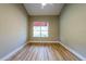 Bright bedroom showcasing wood-look floors, neutral walls and a large window at 2105 Clover Hill Rd, Palm Harbor, FL 34683