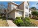 Inviting view of a two-story townhouse, showcasing the manicured front lawn at 2105 Clover Hill Rd, Palm Harbor, FL 34683