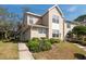 Exterior daytime view of home with a lush green lawn and a cozy neighborhood setting at 2105 Clover Hill Rd, Palm Harbor, FL 34683