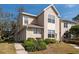 Charming two-story townhouse with light beige siding and well-maintained landscaping at 2105 Clover Hill Rd, Palm Harbor, FL 34683