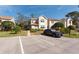Front exterior of the home with parking and manicured landscaping at 2105 Clover Hill Rd, Palm Harbor, FL 34683