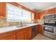 Modern kitchen with stainless steel appliances and stone countertops create a stunning space at 2105 Clover Hill Rd, Palm Harbor, FL 34683