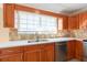 Modern kitchen with stainless steel appliances and stone countertops create a stunning space at 2105 Clover Hill Rd, Palm Harbor, FL 34683