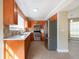 Modern kitchen with stainless steel appliances, wood cabinets, and tile backsplash create a warm, inviting space at 2105 Clover Hill Rd, Palm Harbor, FL 34683