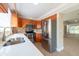 Modern kitchen with stainless steel appliances and stone countertops create a stunning space at 2105 Clover Hill Rd, Palm Harbor, FL 34683