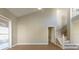 Bright living room with tile floors, staircase, and sliding glass door at 2105 Clover Hill Rd, Palm Harbor, FL 34683