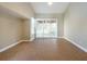Spacious living room with tile floors and large sliding doors allowing for ample natural light at 2105 Clover Hill Rd, Palm Harbor, FL 34683
