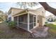 A view of the screened porch with brick access, perfect for outdoor entertaining and relaxation at 2105 Clover Hill Rd, Palm Harbor, FL 34683
