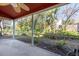 View of the screened lanai featuring tile flooring and access to the backyard, perfect for outdoor living at 2105 Clover Hill Rd, Palm Harbor, FL 34683