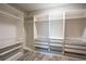 Well-organized walk-in closet with white shelving, drawers, and hanging space for optimal storage at 21698 Amelia Rose Way, Land O Lakes, FL 34637