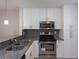 Updated kitchen with stainless steel appliances and grey granite countertops at 2207 S Carolina Ave # 16, Tampa, FL 33629