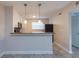 A kitchen view featuring stainless steel appliances, a breakfast bar, and modern pendant lighting at 2207 S Carolina Ave # 16, Tampa, FL 33629