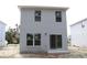 Rear elevation of a two-story home with sliding glass doors and three windows at 2222 E Emma Street, Tampa, FL 33610