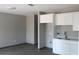 Modern kitchen featuring white cabinets, gray walls and floors with a sink at 2222 E Emma Street, Tampa, FL 33610