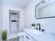 Modern bathroom with shower featuring marble vanity, new lighting, and updated fixtures at 245 58Th N St, St Petersburg, FL 33710