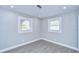 Bright bedroom with modern gray vinyl floors, fresh paint and two windows at 245 58Th N St, St Petersburg, FL 33710