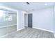 Inviting bedroom with mirror closet, fresh paint, modern laminate floors, and doorway at 245 58Th N St, St Petersburg, FL 33710