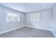 Well-lit bedroom with wood-look floors, neutral walls, and bright windows at 245 58Th N St, St Petersburg, FL 33710