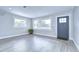 Bright living room featuring laminate flooring, large windows, and fresh paint at 245 58Th N St, St Petersburg, FL 33710