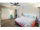 Bedroom features a ceiling fan, double door closet, a window and comfortable decor at 25152 Aysen Dr, Punta Gorda, FL 33983