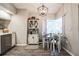 Cozy kitchen nook with a modern light fixture, adjacent cabinet space, and a large sunlit window at 25152 Aysen Dr, Punta Gorda, FL 33983