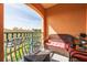 Cozy balcony featuring a wicker couch, wrought iron railing, and an orange painted exterior at 2722 Via Tivoli # 430A, Clearwater, FL 33764