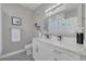 Stylish bathroom featuring patterned floors, a vanity with countertop space and a large, framed mirror at 2722 Via Tivoli # 430A, Clearwater, FL 33764