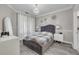 Well-lit bedroom with grey wood floors, a decorative light fixture, and flower decorations at 2722 Via Tivoli # 430A, Clearwater, FL 33764